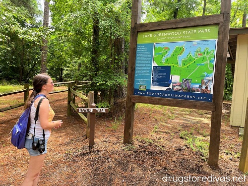 A woman looking at a trail map in Lake Greenwood State Park.