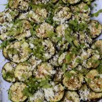 Grilled zucchini on a tray with the words 