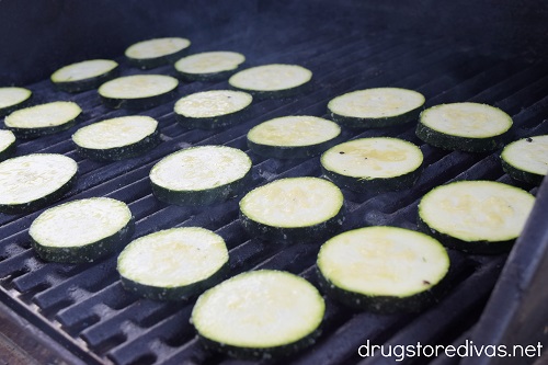 Zucchini slices on a grill.