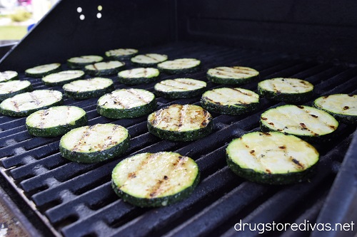 Zucchini with grill marks on it on a grill.