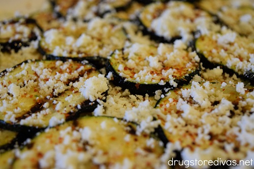 Crumbled cheese on top of grilled zucchini.