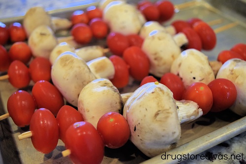 Tomato and mushroom skewers on a tray.