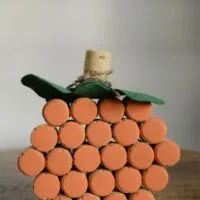 A pumpkin made out of wine corks with the words 