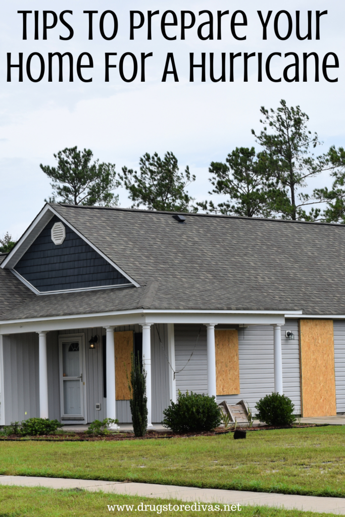 A home with plywood on the windows and "Tips To Prepare Your Home For A Hurricane" digitally written on top.