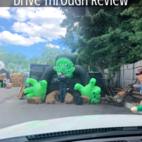An inflatable Frankenstein in a drive through parking lot with the words 
