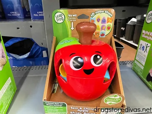 A LeapFrog Spin and Change Apple Shape Sorter on a shelf.
