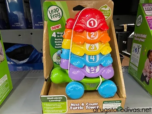 A Leapfrog Nest And Count Turtle Tower toy on a shelf.