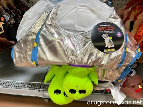 A pet alien ride on Halloween costume on a shelf in a store.