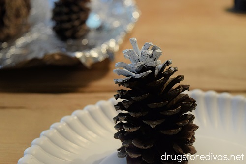 A pine cone with a white painted top.
