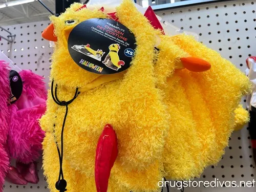 A chicken pet costume on a shelf.