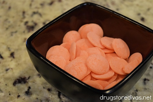 Orange candy melts in a bowl.