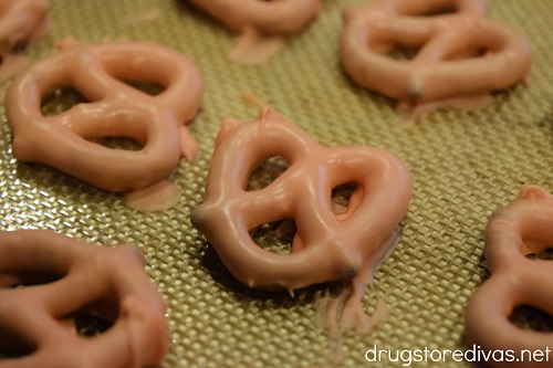 Orange pretzel twists on a silicone baking mat.