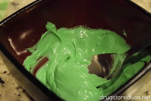 Green candy melts melted in a bowl.