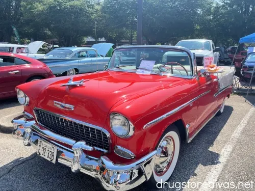 A red classic car in a car show.