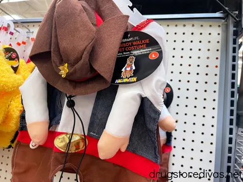 A cowboy pet costume on the shelf in a store.