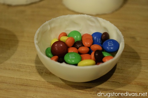 A white chocolate dome filled with M&M's and mini Reese's Pieces.