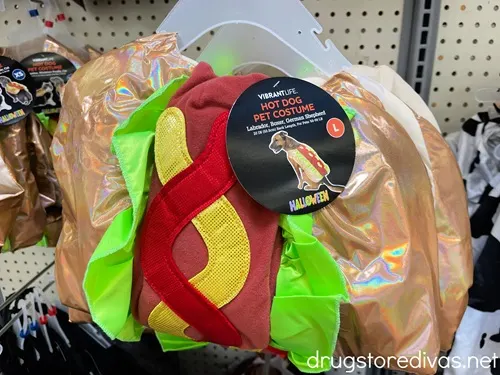 A hot dog pet costume on a shelf.