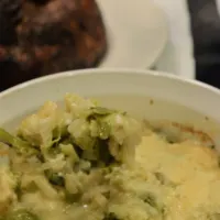A turkey in the back and a casserole in the front with the words 