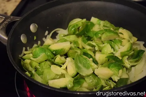 Brussels sprouts and onions in a pot.