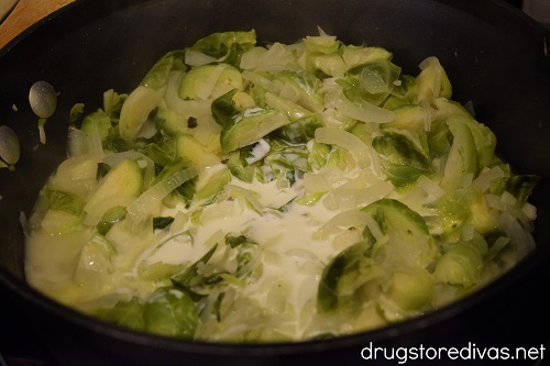 Brussels sprouts and onions in a cream sauce a pot.
