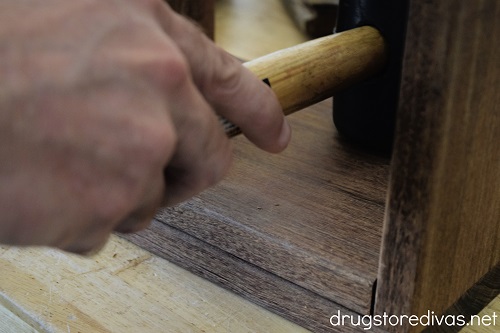 A mallet hitting boards of wood.