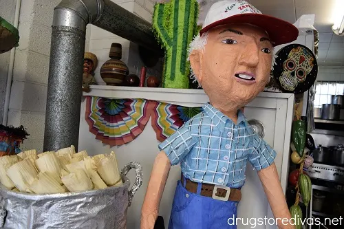 A paper mache model of a man and tamales. 