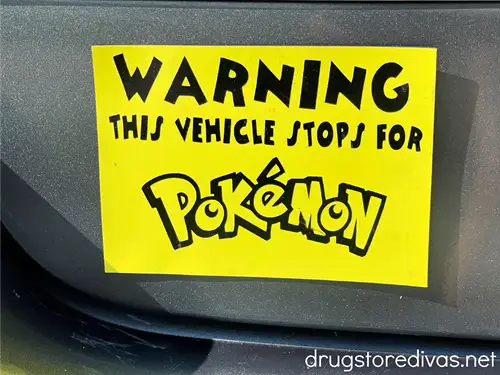 A yellow bumper sticker that says "Warning This Vehicle Stops For Pokemon."