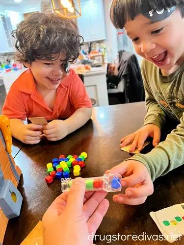 Tow young boys playing a pirate board game together.