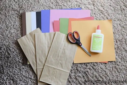 Paper bags, card stock, scissors, and glue.