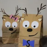 Two gift bags made to look like reindeer with the words 