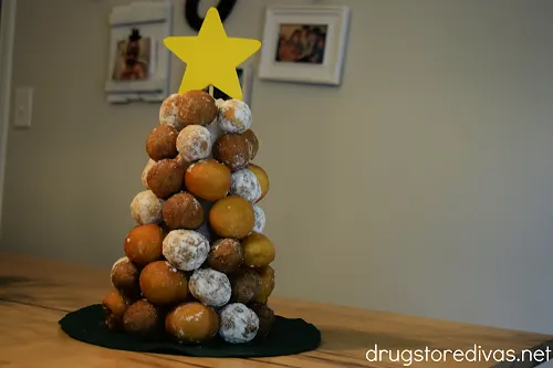 A Christmas donut hole tree on a table.
