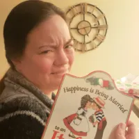 A woman holding a plaque and rolling her eyes with the words 