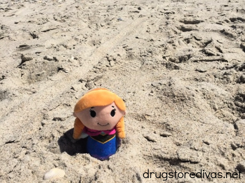 Anna from Frozen stuffed doll in the sand.