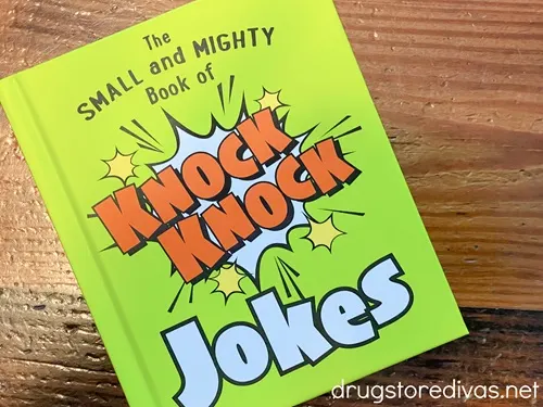 A neon green book called "The Small And Mighty Book Of Knock Knock Jokes".