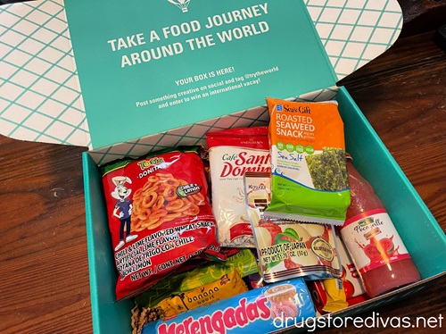 A teal box from Try The World filled with snacks.