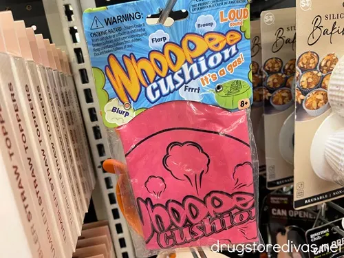 A Whoopee Cushion in a bag on a peg in a store.