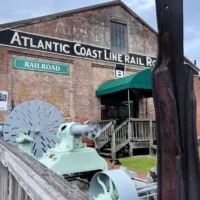 The outside of the train museum in Wilmington, NC with the words 