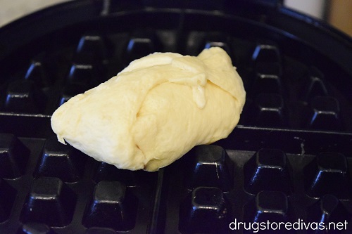 A crescent roll on a waffle maker.