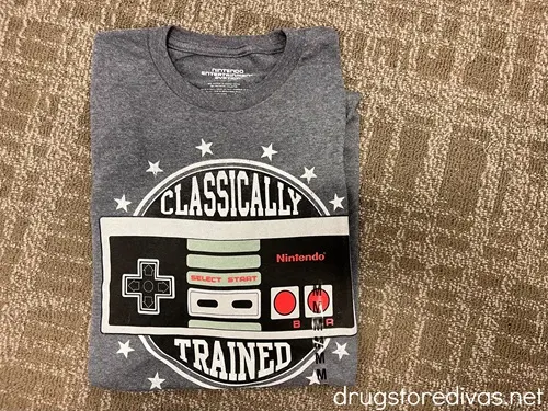 A gray shirt with a Nintendo controller image on it and the words "Classically" above it and "Trained" below it.