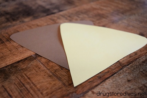 A pizza shape cut from yellow and brown card stock.