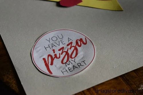 A circle with the words "You Have A Pizza My Heart" glued onto card stock.