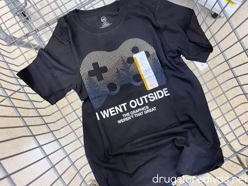 A black shirt that says "I went outside and the graphics weren't that great" in a shopping cart.
