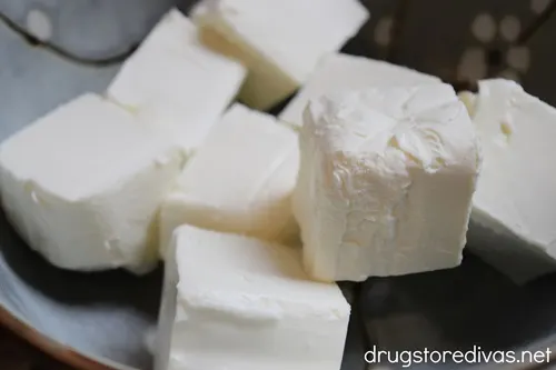 Cubes of cream cheese in a bowl.