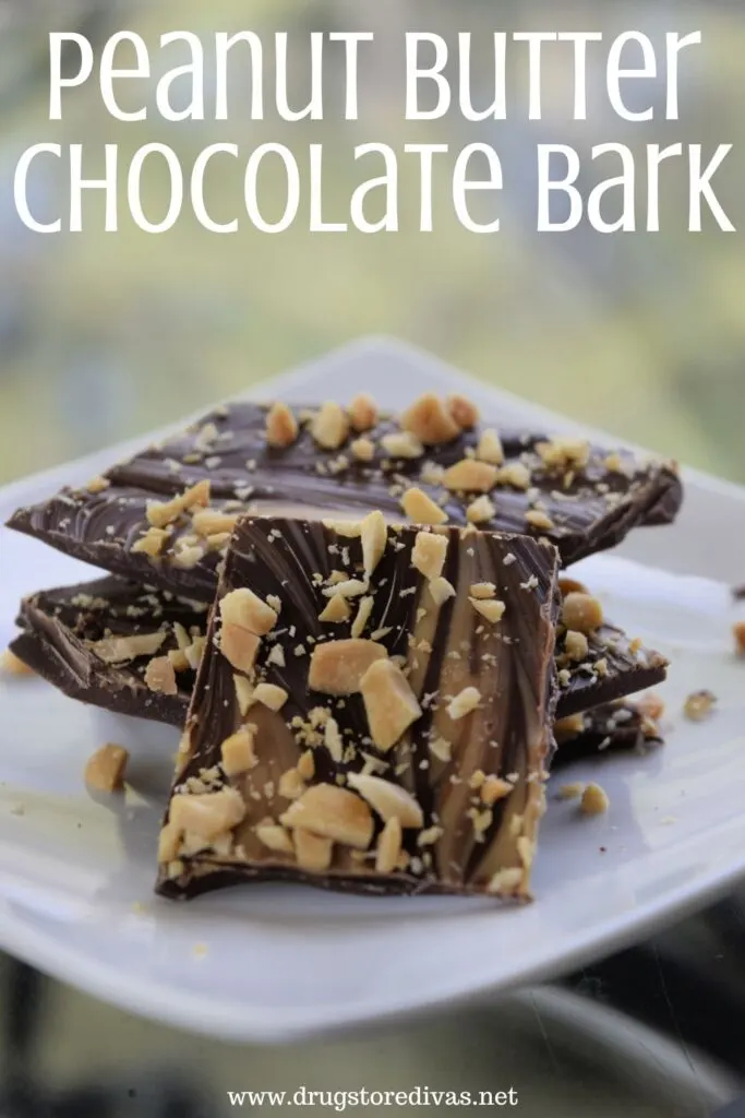 Pieces of chocolate bark with peanuts on it on a plate with the words "Peanut Butter Chocolate Bark" digitally written on top.