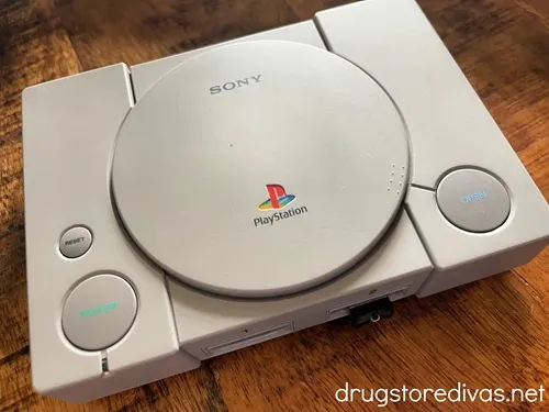 A Playstation Classic Console on a wooden table.