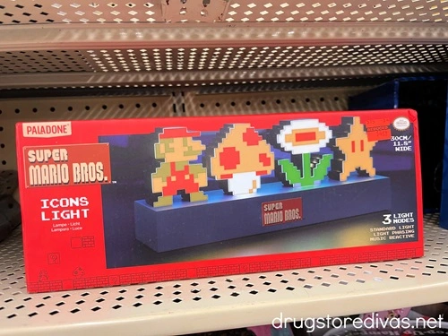 A Super Mario Bros Icon Light in a box on a shelf.