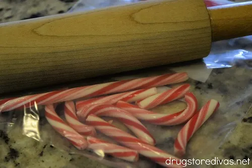 Candy canes being crushed by a rolling pin.