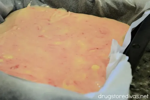 Pink and white fudge in a pan.