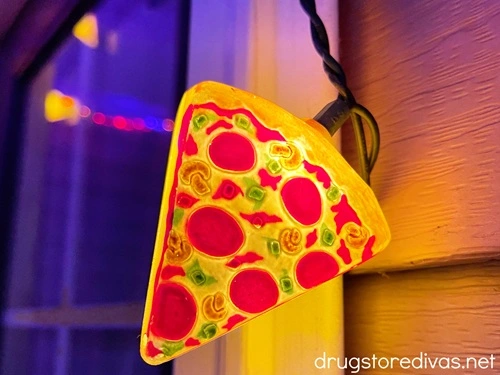 Pizza string lights hanging outside of a house.