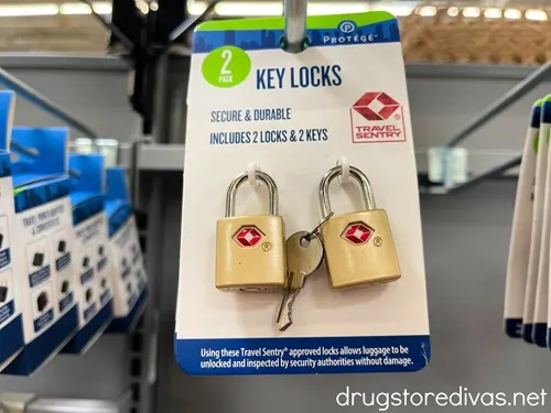Two gold TSA approved luggage locks and keys in a package on the shelf in Walmart.